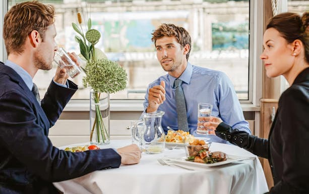 Friends dining on Danube River cruise, enjoying a meal together.