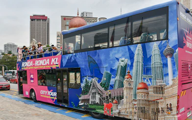 Passengers on a double-decker bus during the Kuala Lumpur Hop-On Hop-Off Tour.