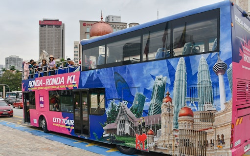 Passengers on a double-decker bus during the Kuala Lumpur Hop-On Hop-Off Tour.