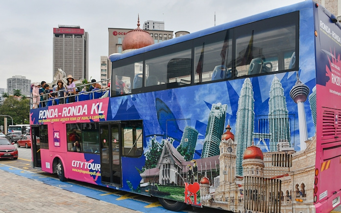 Passengers on a double-decker bus during the Kuala Lumpur Hop-On Hop-Off Tour.
