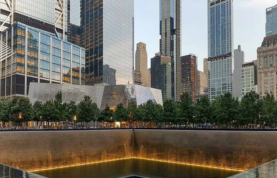 Ground Zero tour group at 9/11 Memorial near museum entrance, New York City.