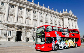 Red Madrid City Tour bus in front of the Royal Palace, Madrid.
