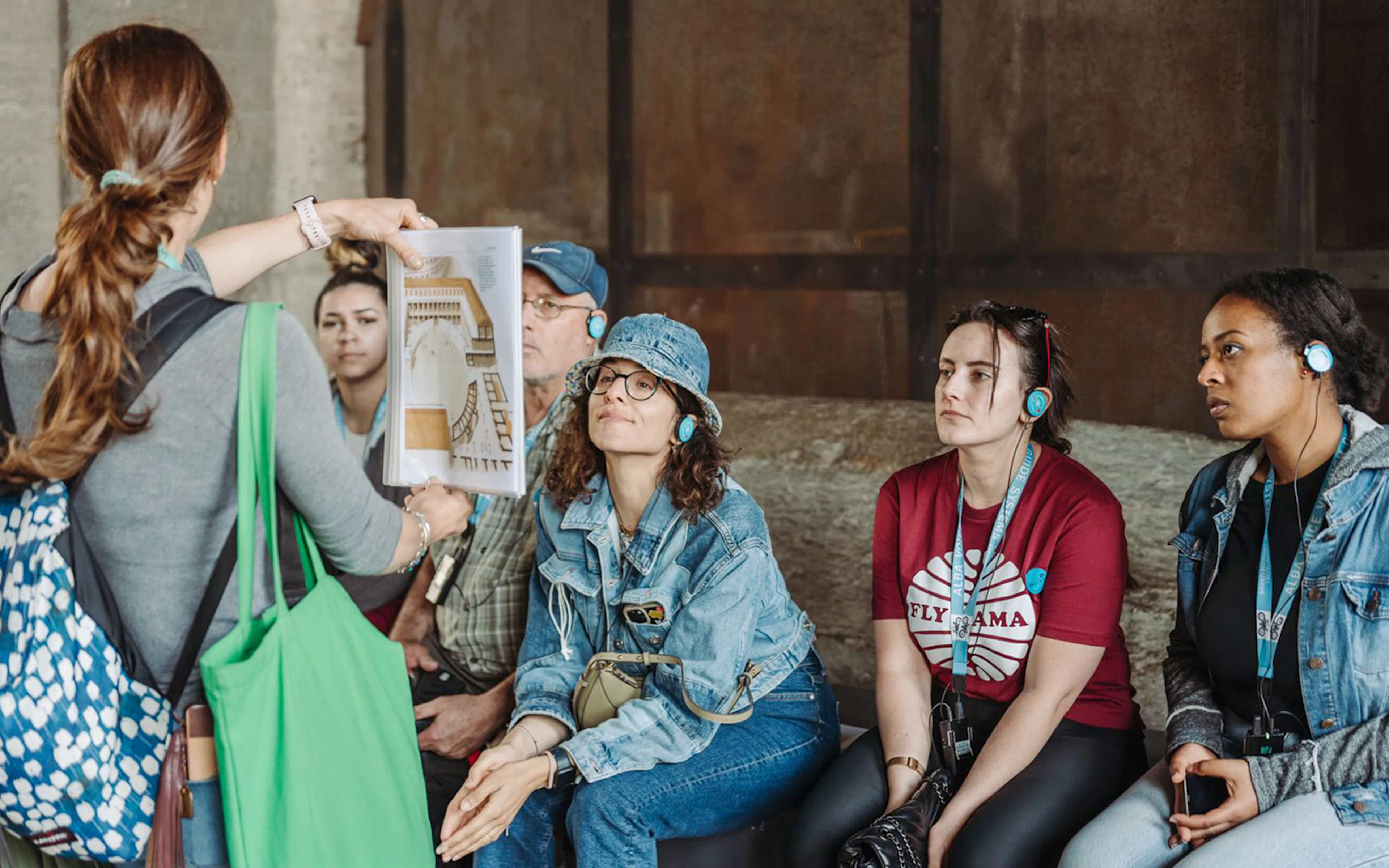 Tour guide showing a diagram to participants at the Colosseum.