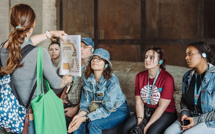 Tour guide showing a diagram to participants at the Colosseum.