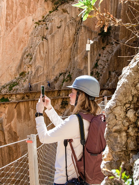Hiker taking a photo on the Caminito del Rey trail in Malaga.