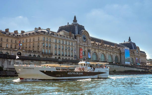 Cruise boat on the Seine passing Musée d'Orsay in Paris.