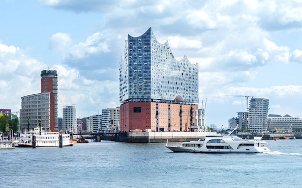 Cruise boat near Elbphilharmonie in Hamburg harbor.