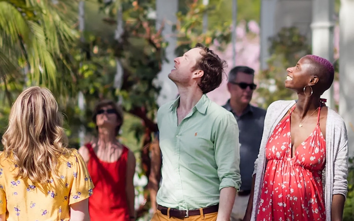 Visitors enjoying the greenery at Kew Gardens.