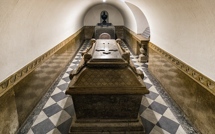 Crypt interior with ornate sarcophagus under Wawel Castle Cathedral, Krakow.