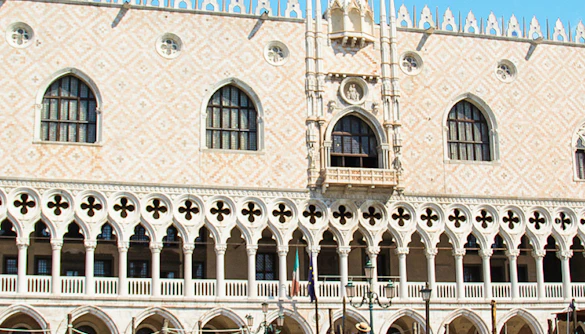 Gondolas in front of Doge's Palace exterior in Venice, Italy.