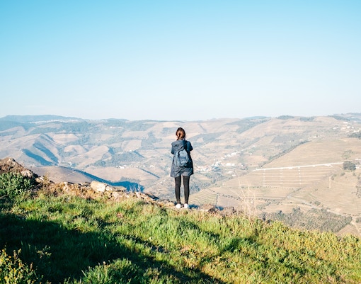 Hiker overlooking vineyards in Douro Valley during Provesende to Pinhão hike.
