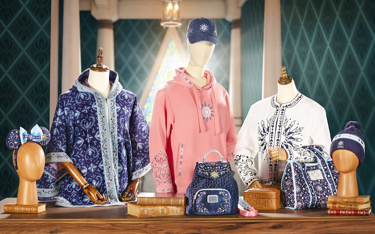 Disneyland World of Frozen merchandise display with themed clothing and accessories.