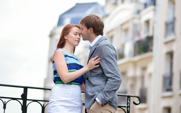 Couple embracing during a professional photoshoot in Montmartre, Paris.