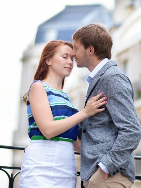 Couple embracing during a professional photoshoot in Montmartre, Paris.