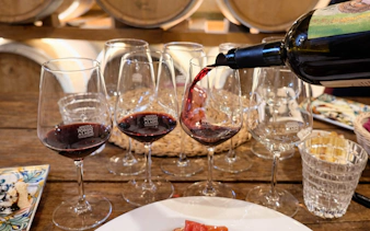 Wine being poured into glasses during Chianti day trip in Italy.