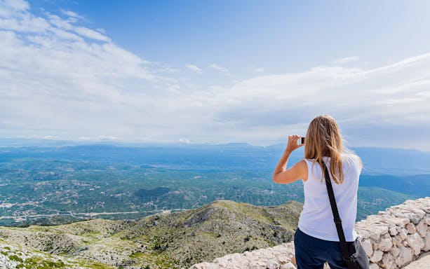 Person photographing Biokovo mountain view from Makarska.