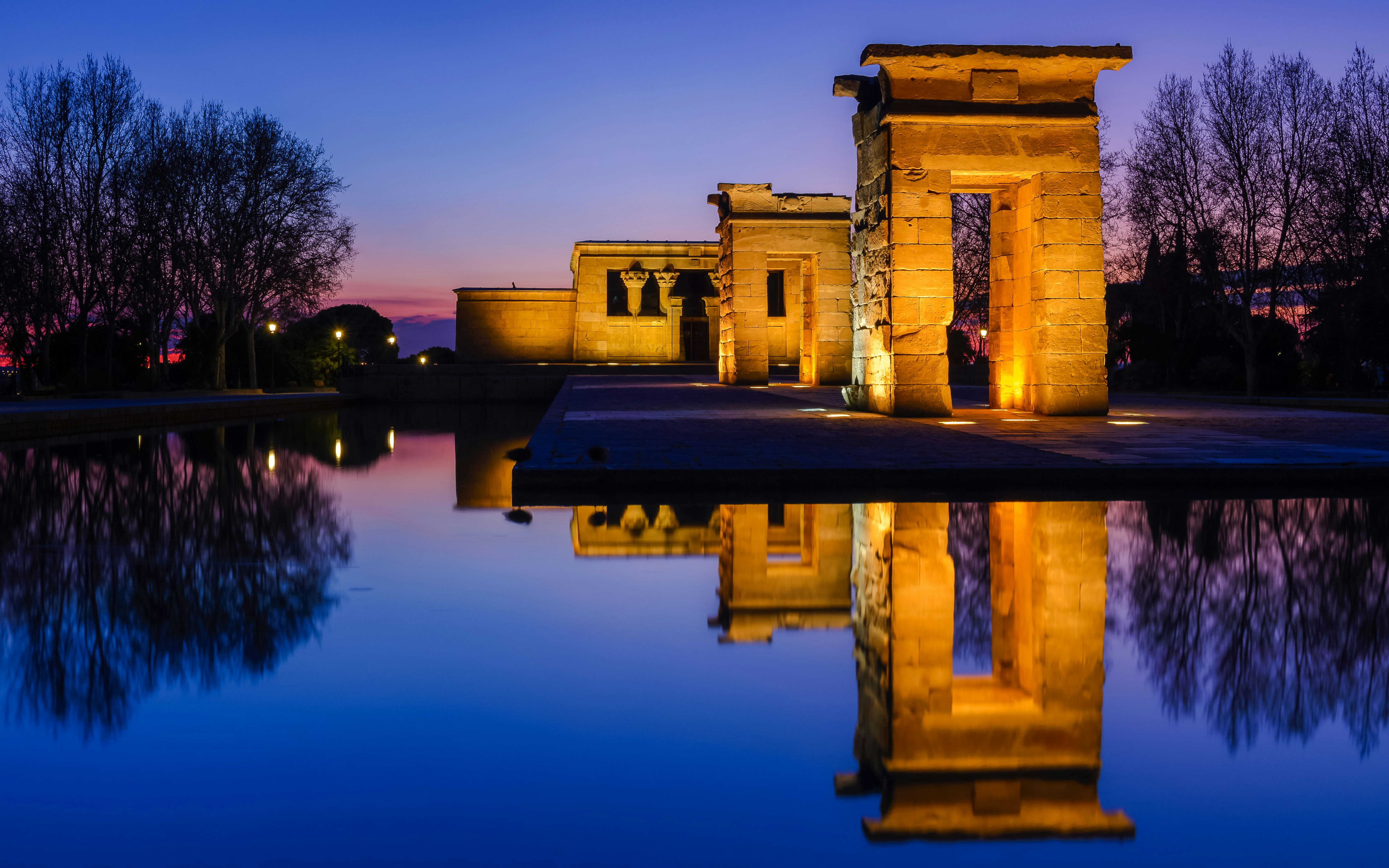 Temple of Debod illuminated at night with reflection in water, Madrid, Spain.