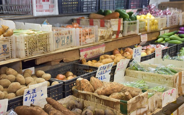 Market stall with fresh vegetables and root crops for Market to Table Culinary Tour.