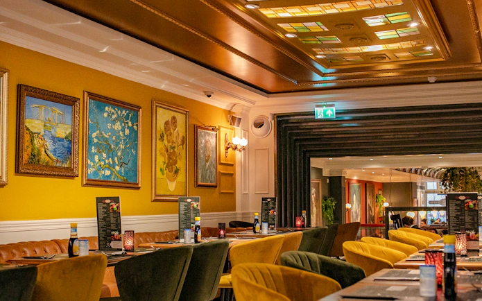 Dining area with art on walls, part of Rembrandt tour with House Museum and brunch, Amsterdam.