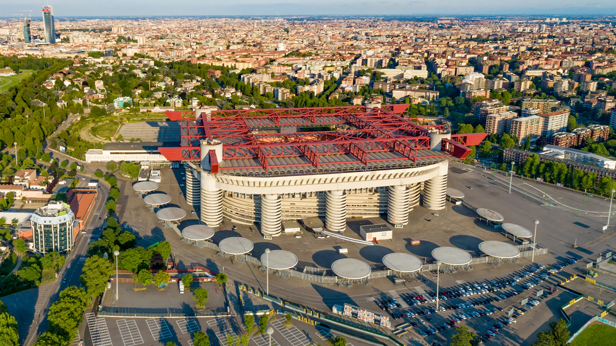 Aerial view of San Siro Stadium in Milan surrounded by cityscape.