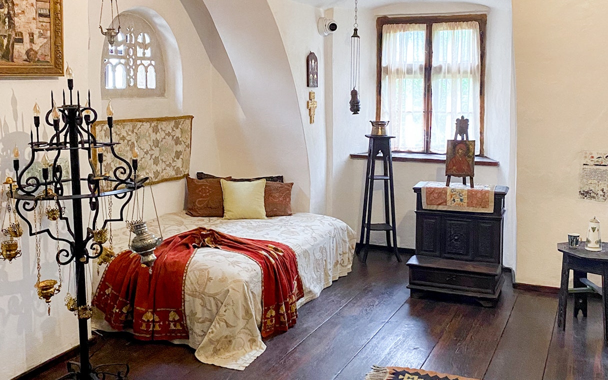 Bran Castle interior, Queen Mary's bedroom with ornate bed and vintage decor, Romania.