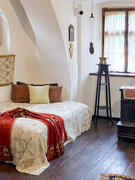 Bran Castle interior, Queen Mary's bedroom with ornate bed and vintage decor, Romania.