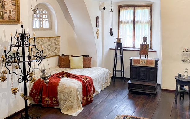 Bran Castle interior, Queen Mary's bedroom with ornate bed and vintage decor, Romania.