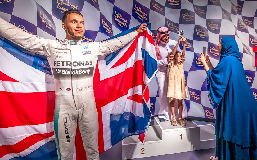 Lewis Hamilton wax figure with British flag at Madame Tussauds Dubai.