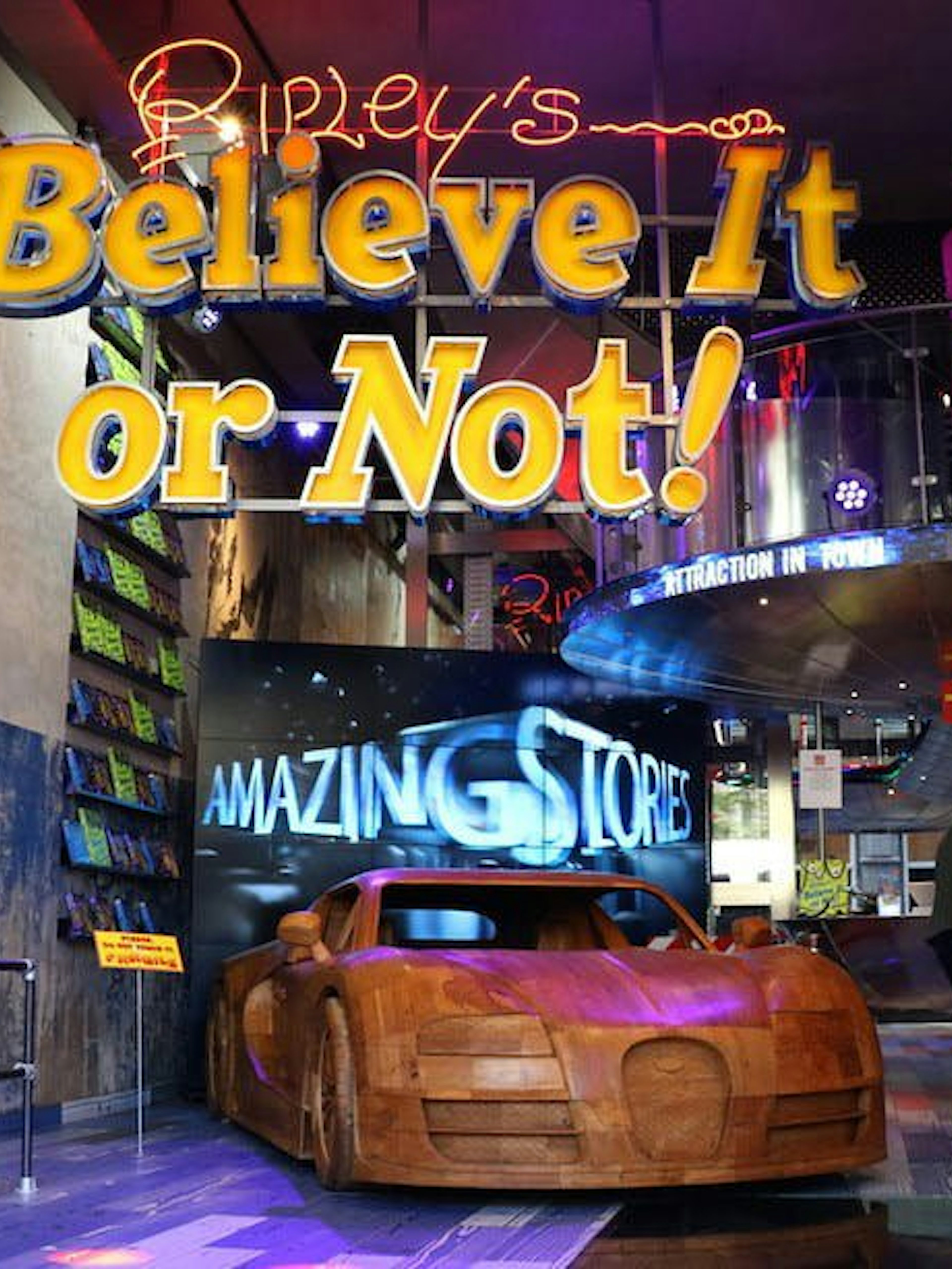 Ripley's Believe It or Not! entrance with wooden car exhibit and visitors exploring.