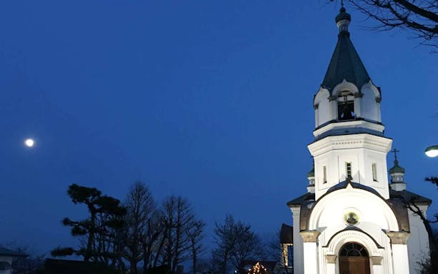 Orthodox church at night with moon in Hakodate, Japan.