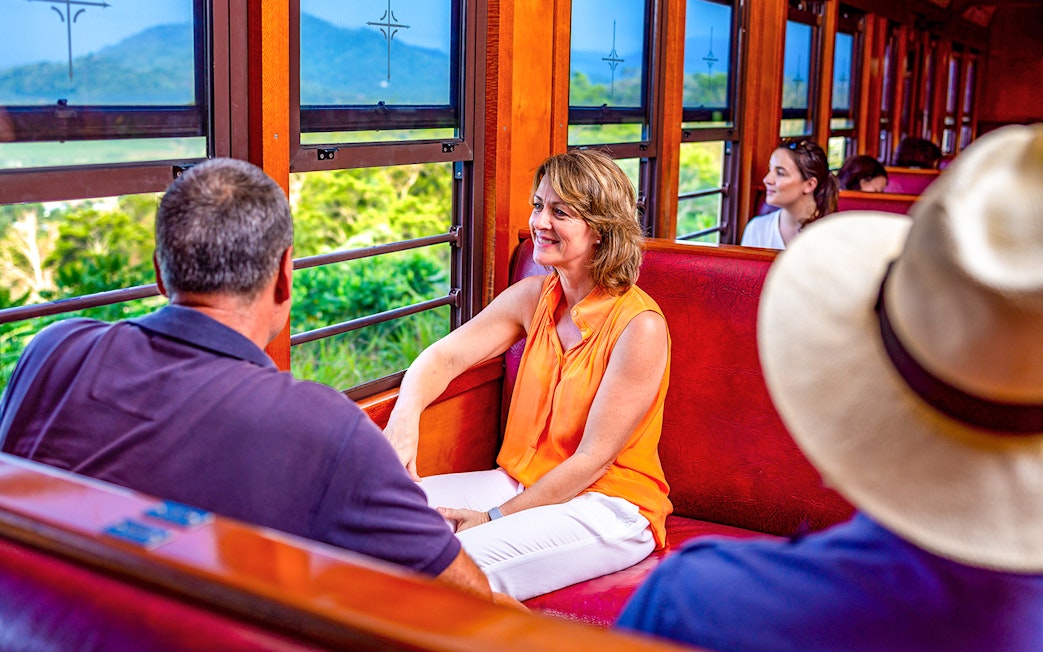 Couple enjoying scenic views inside the Kuranda train in Australia.