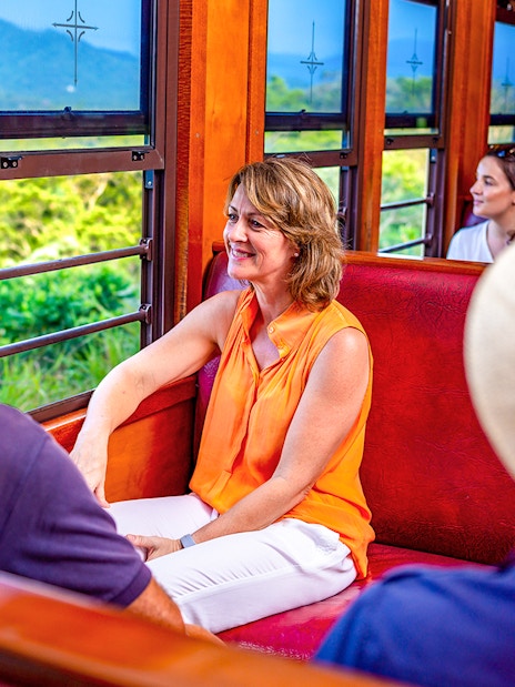 Couple enjoying scenic views inside the Kuranda train in Australia.