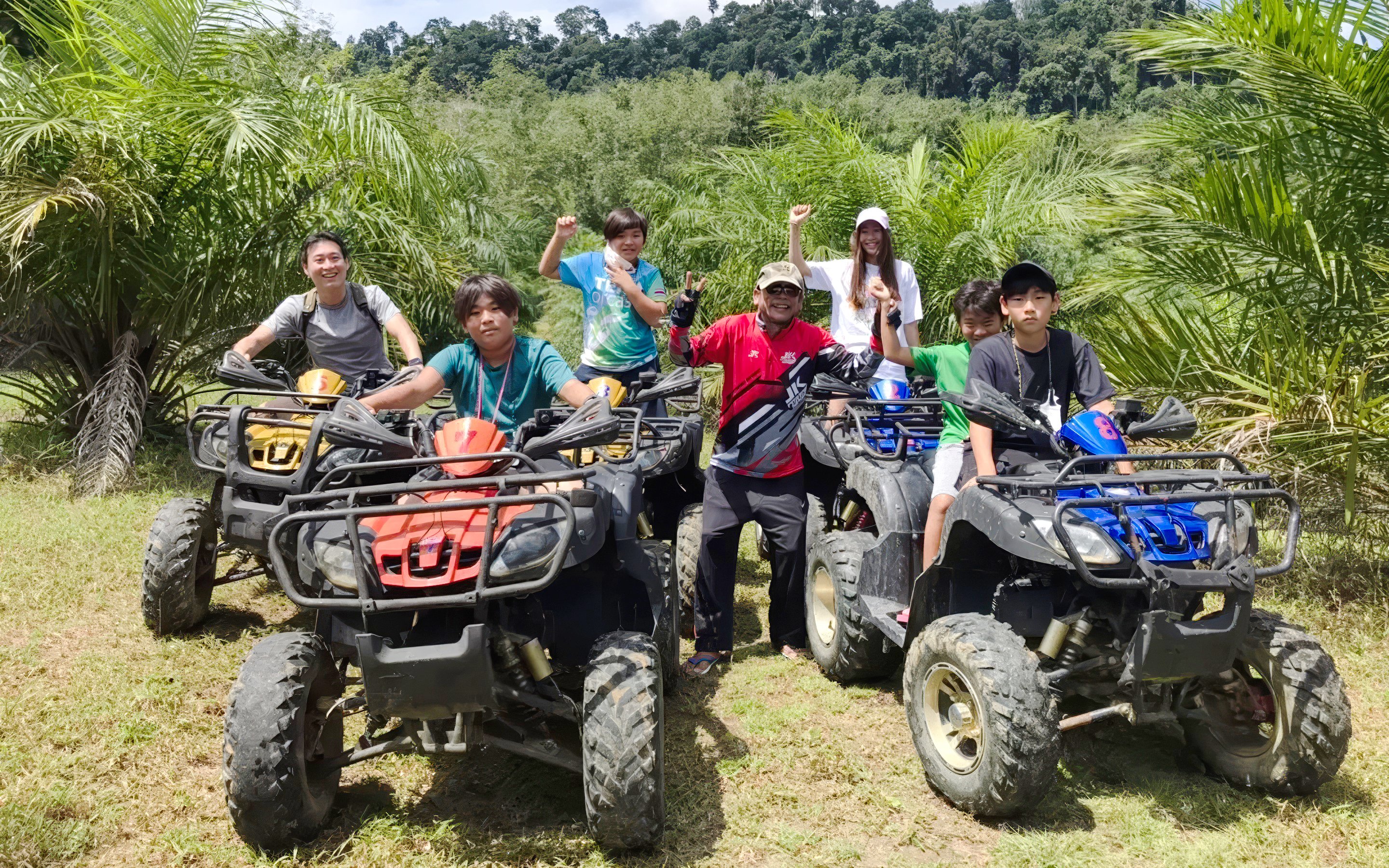 Group enjoying an ATV ride through lush greenery.