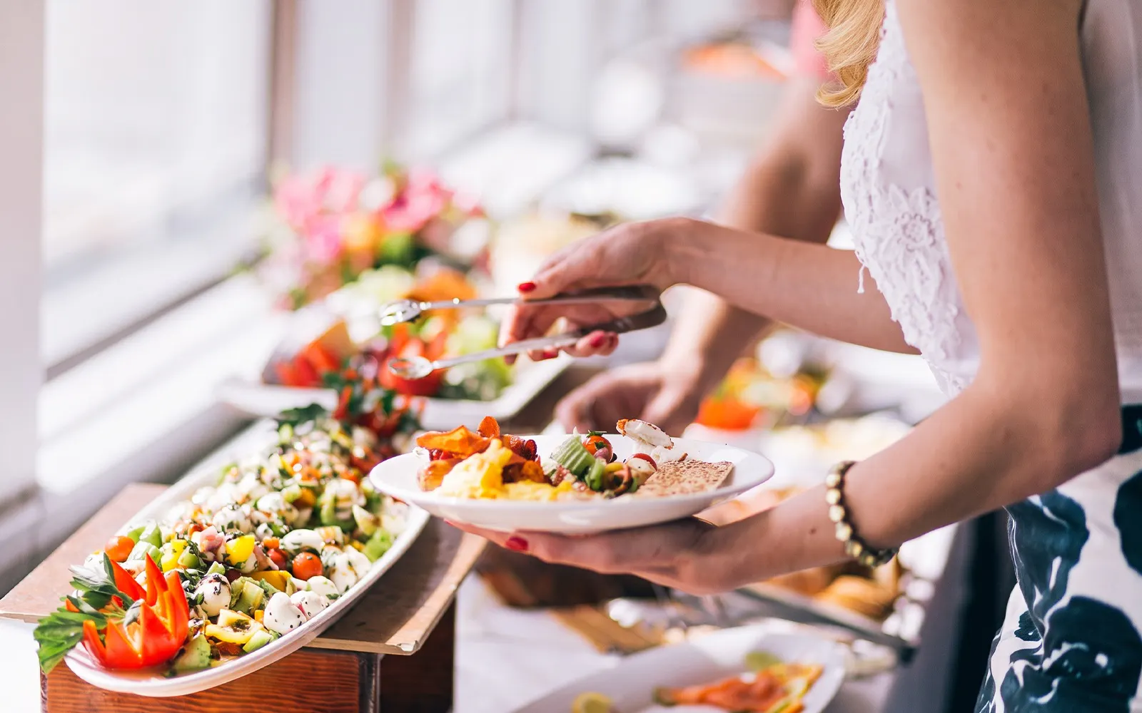 Guest serving food from a buffet on the Long Beach Signature Dinner Cruise.