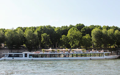 Seine River cruise boat with dining area, Paris.