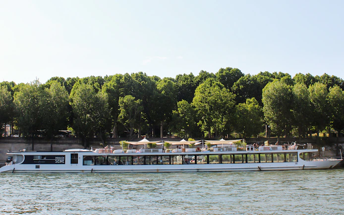 Seine River cruise boat with dining area, Paris.