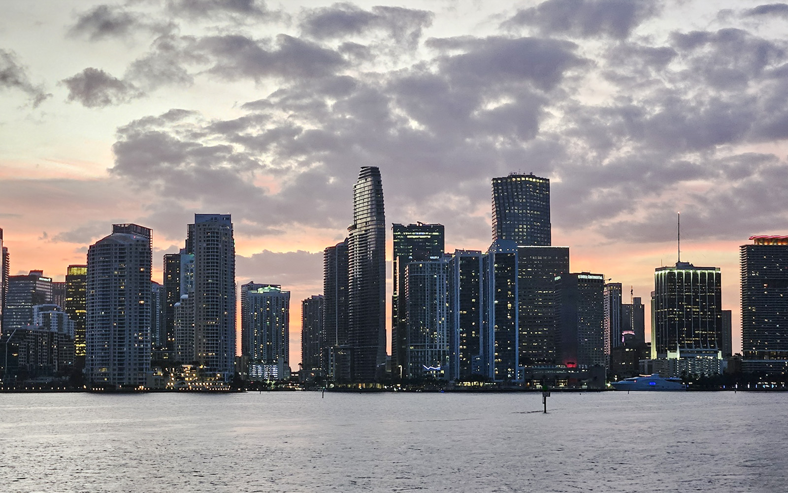 Miami skyline at sunset viewed from a cruise on the water.