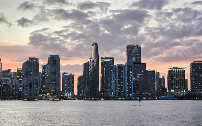 Miami skyline at sunset viewed from a cruise on the water.