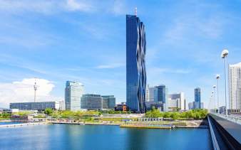 DC Tower in Vienna with surrounding skyline and river view.