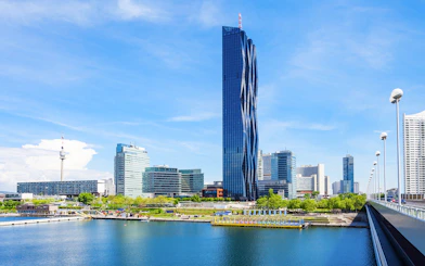 DC Tower in Vienna with surrounding skyline and river view.