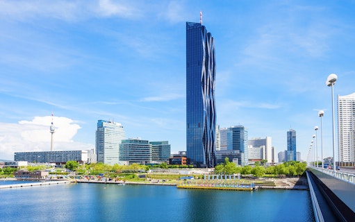 DC Tower in Vienna with surrounding skyline and river view.