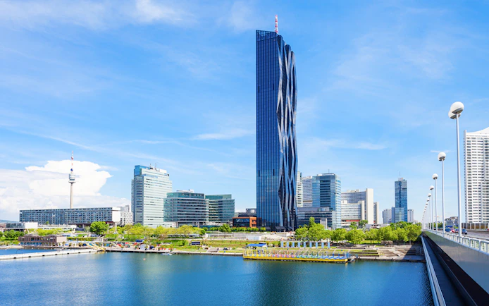 DC Tower in Vienna with surrounding skyline and river view.