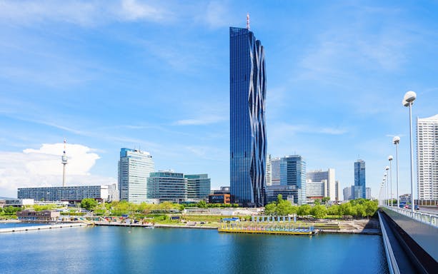 DC Tower in Vienna with surrounding skyline and river view.