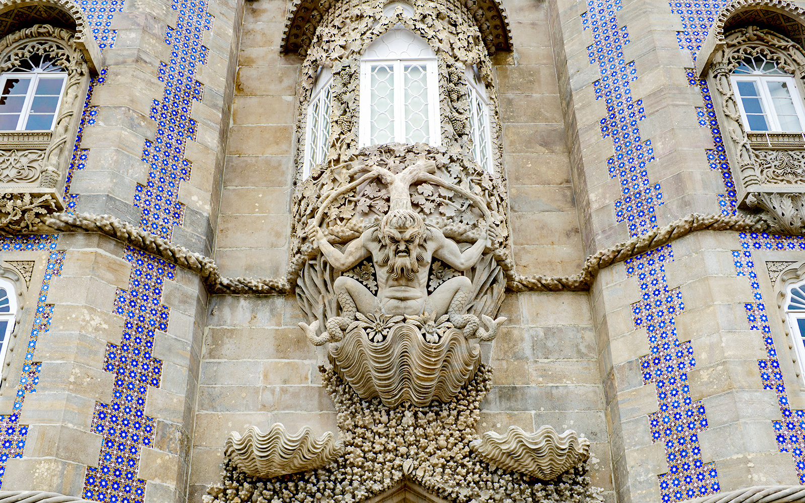 Facade detail of National Palace of Pena with intricate stone sculpture, Sintra, Portugal.