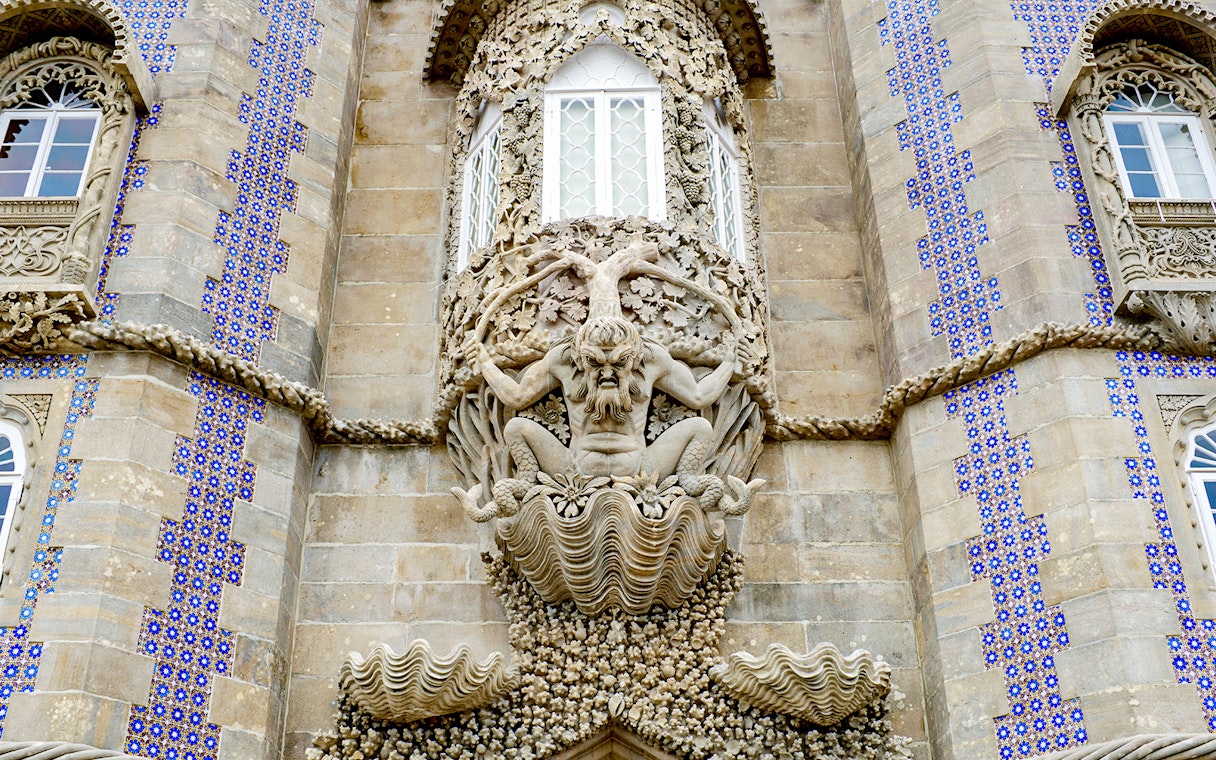 Facade detail of National Palace of Pena with intricate stone sculpture, Sintra, Portugal.
