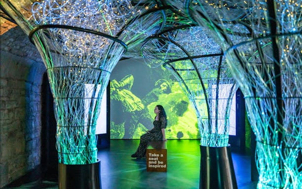 Interactive exhibit with illuminated structures and digital art at epic museum.