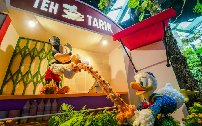 Mickey and Donald topiary figures at Disney Garden of Wonder, pouring tea at Teh Tarik stall.