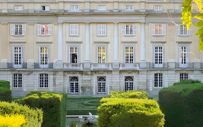 Liria Palace Garden with manicured hedges and classical facade, Madrid.