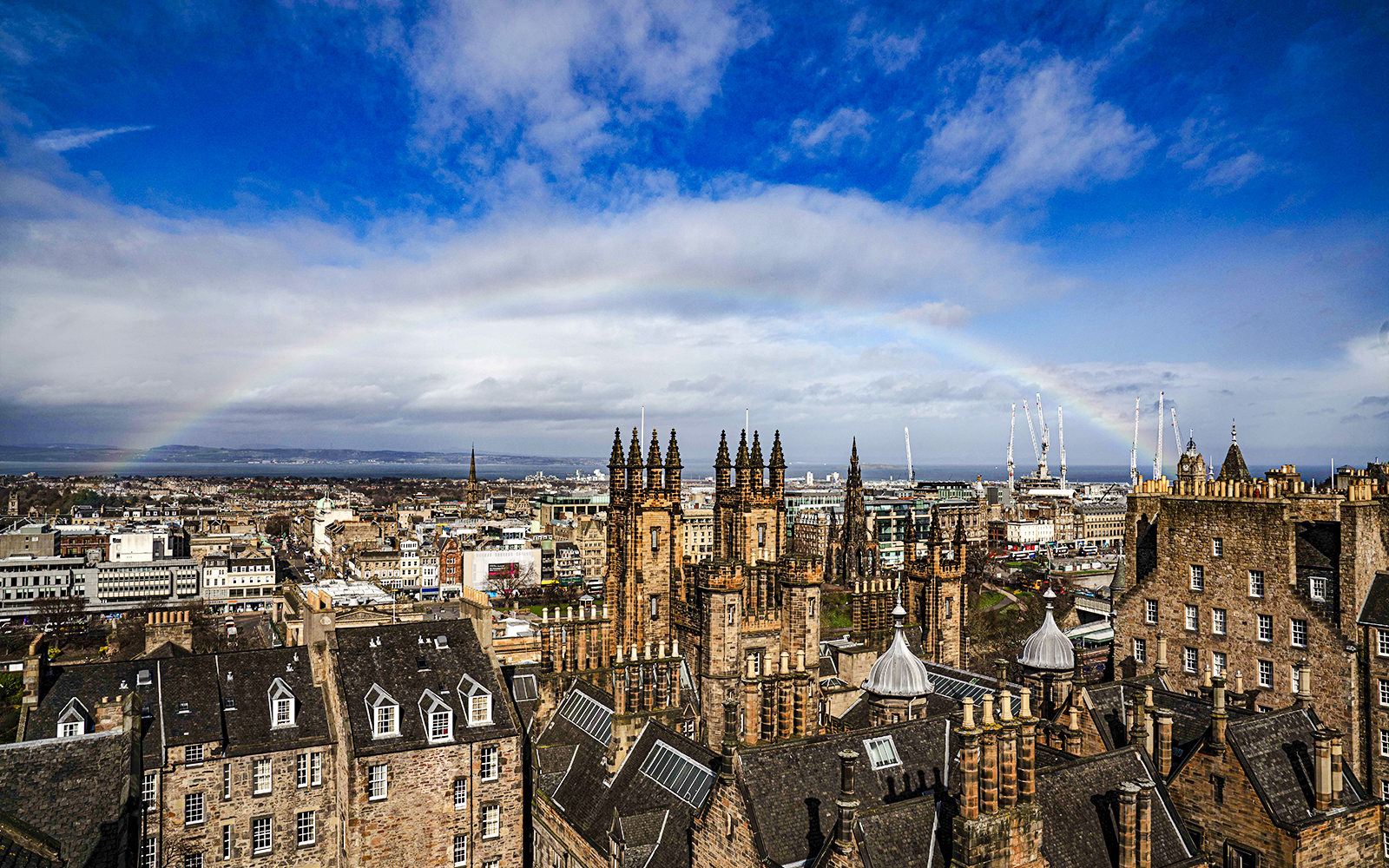 Edinburgh skyline with historic buildings and rainbow from Camera Obscura & World of Illusions.