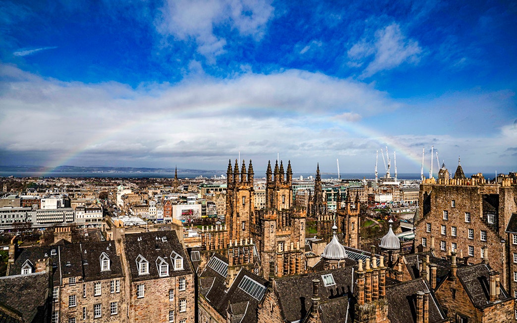 Edinburgh skyline with historic buildings and rainbow from Camera Obscura & World of Illusions.